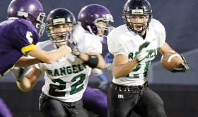 Colton Coombs, who had 23 tackles and a fumble recovery, blocks for teammate Chas Byerly.