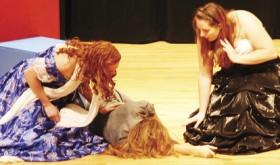 Marie (Chelsea Ficken, left) and Giselle (Kymberlie Hemphill) try to revive Madame Pompadour (Leslie Hernandez) after threats made by the mysterious Phantom of the Opera.
