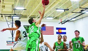 Rangely High School junior Andrew Morton (22) making a side shot. Andrew was high scorer against Plateau Valley. Junior Cameron Enterline (13) and sophomore Luis Contreras (20) assist.