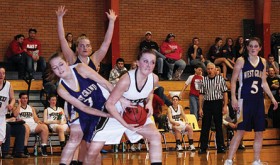 Meeker senior Kacey Collins fights for a rebound against West Grand.