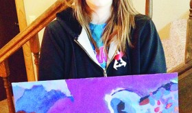 Rangely High School sophomore Jess Tolley holds her painting of a snow leopard, which was chosen to be included in the annual Celebrating Art publication last year. Tolley’s pencil drawing of an angel was selected for this year’s publication.