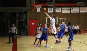 CNCC sophomore guard Thomas Powers, this year’s second highest scorer in the Scenic West Athletic Conference (SWAC), drives to the basket against Salt Lake Community College defenders. Despite losing several players early in the season, the Spartans played competitively at the SWAC Region 18 tournament Feb. 28, 
losing narrowly to Snow College.