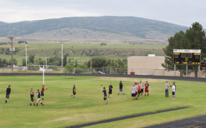 With music blasting from the speakers in Starbuck Stadium, Meeker High School players warm up with a passing drill Monday. Many players have been gathering on their home field on Mondays and Thursdays all summer in preparation of the upcoming season. Practice officially starts Aug. 11 and the annual Cowboys Kickoff Classic golf tournament will be played Aug. 16.