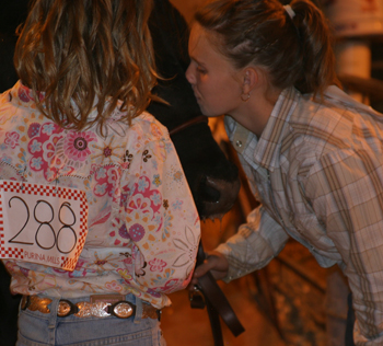 Shelby Burke gives a good-luck kiss before entering the livestock arena while showing during the county fair.