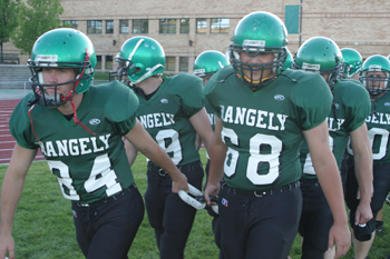 Captains Adam Dahl, left, and Kindal Cushman, right, lead their teammates onto the field before Friday’s game carrying a heavy-duty chain. “We need to be like links in a chain,” said coach Tim Galloway. “Everybody has a job to do.”