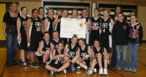 Members of Meeker’s eighth-grade basketball teams, along with head coach Deb Henderson, left, and assistant coach Nicole Dupire, right, posed for a group photo after winning the league tournament Saturday.