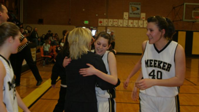 phsptmkgirlsbasketball7 Elissa McLaughlin hugged coach Hallie Blunt as Rebecca de Vergie, right, and fellow teammates celebrated at the conclusion of Saturday’s come-from-behind victory in the first round of districts. The Lady Cowboys continue on to the next round Friday at Rangely.