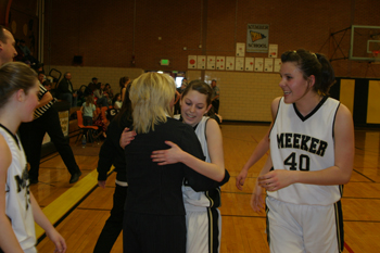 Elissa McLaughlin hugged coach Hallie Blunt as Rebecca de Vergie, right, and fellow teammates celebrated at the conclusion of Saturday’s come-from-behind victory in the first round of districts. The Lady Cowboys continue on to the next round Friday at Rangely.