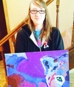 Rangely High School sophomore Jess Tolley holds her painting of a snow leopard, which was chosen to be included in the annual Celebrating Art publication last year. Tolley’s pencil drawing of an angel was selected for this year’s publication. 