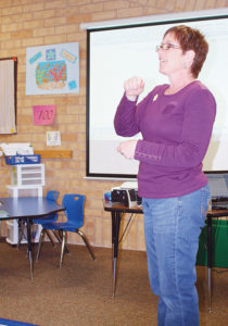 Third-grade teacher Becky Bertoch explains to parents how she uses the Step Up to Writing program with her students. 