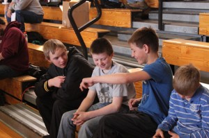 Clay Anderson, left, and Daylon Nielsen, right, talk with sixth-grader Tannen Kennedy before wrestling at the recent Barone Middle School tournament. Anderson was incorrectly identified using his brother’s name in last week’s issue of the Herald Times, which also listed him as a seventh-grader and that neither wrestler placed. Anderson is an eighth grader who placed fifth in the tournament and Nielsen finished in fourth place.