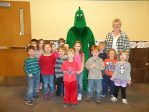 January was Fossils and Mammoths month at the library. Students brought in great fossils to  display. They learned about mammoths and ice age creatures using the educational mammoth kits loaned to us by the mammoth site in Hot Springs, S.D.  Colorado is full of mammoth sites. In 2010, near Snowmass, Colo., a bulldozer operator found huge mammoth bones near what was a watering hole during the ice age. The small lake was used by ancient elephants such as mammoths and mastodons. There have been 4,826 fossils found at the site in the 69-day dig period. Bones from 40 different mastodons of all ages were unearthed. The site would be a great place to visit this summer. To cap off library month we were thrilled to have a big green prehistoric visitor. He came to lunch and visited the classes.