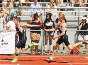 Meeker’s Jeff Wagner receives the baton from Anthony Watt in this first exchange of the 4x100-meter relay team, which finished third. 