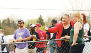 RHS graduate Leslie Kurtz, a two-time state shot put champ, talks with Holly Lepro between discus throws. Lepro broke Kurtz’ school discus record this season, which had stood since 2000.