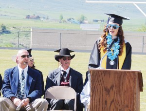 High school and school district officials look on Saturday morning as Amanda Kendall, the salutatorian for the MHS Class of 2013, addressed her fellow seniors, reviewing the good times the students had along their lengthy journey to graduation. The students were presented their diplomas by the Meeker School District Board of Education. Also speaking at the commencement was class valedictorian Emily Eliasen, who passed her colorful mantle on to Taylor Neilson and Piper Haney, who will be seniors in the Class of 2014.