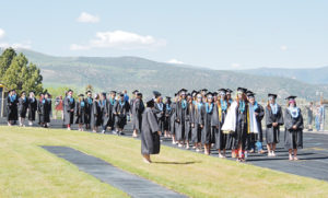 Seniors in the Meeker High School Class of 2013 lined up on the track at Starbuck Stadium moments before starting the procession to their seats for commencement. Clear skies and sun mixed with the green hills in the background to make for a great day for the 47 members of the class as they passed one of the major milestones in one’s life.