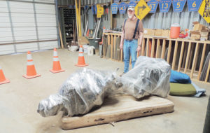 sean mcmahon Ground preparation is complete for the Rio Blanco County Veterans Memorial on the county courthouse lawn in Meeker, but actual stone and concrete construction of the base is expected to start this week so the statue of the solder, to be dubbed “Sacrifice and Resolution” will be dedicated after the parade July 4. Seen with the plastic-wrapped statue that will top the memorial is Joe Dungan, the veterans service officer for Rio Blanco and the Meeker VFW post.