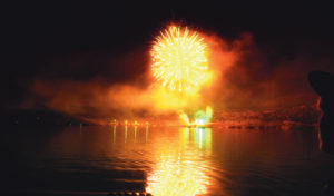 TRACY ENTERLINE A gorgeous display of fireworks reflects in the waters of Kenney Reservoir, located just east of Rangely, on Thursday night. The fireworks display kicked off several holiday events in Rangely over the weekend, including a surf ‘n’ turf dinner, a color run in which runners are pelted with colored chalk, and a rib cook-off competition.