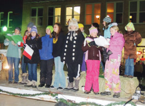 Several members of the Meeker Girls’ Choir endured icy temperatures and an added slight windchill Friday night to serenade town residents and visitors who made it to the Meeker Christmas tree lighting and Parade of Lights. In spite of below-zero temperatures, the choir sang an impressive array of holiday songs a cappella — without music.