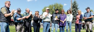Eddie O'Brien, the community liaison for The Colorado Grand, presented a couple of checks Sept. 11 as the charitable organization's vintage sports cars rolled through town, with a stop at City Park, which included lunch served by the Meeker Lions Club. "We've been coming to Meeker for at least a half dozen times. We put on this event once a year. It's a four-day event that runs through the state of Colorado," O'Brien said. "We raise a lot of money. We'll give away between $300,000 and $400,000 per year to all of the communities we go through." O'Brien presented checks for $7,500 to the Meeker Lions Club and a $7,500 check for a local student going to a college or university in Colorado. Paul Jordan and Julie Pearce accepted on behalf of the Meeker Lions Club. 