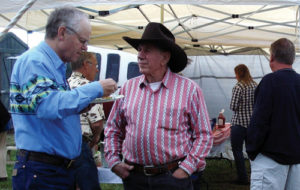 Dr. Albert Krueger, left, enjoys a hamburger during the Coal Creek School Benefit Dessert Social held Saturday evening at the Buford School. The social was to raise money for restoring the Coal Creek School to its near-original condition, and roughly $1,500 was raised.
