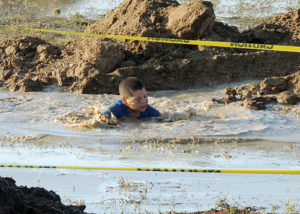 This young gentleman had to use his swimming skills to complete the Muddy Dip ‘N’ Dash obstacle on Sunday evening at the old Parkview school site as part of Septemberfest. Dozens of youths and adults took part in the obstacle course, which left a good percenage of Rangely students and several adults caked in juicy mud, courtesy of  the Rangely Fire Department.