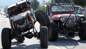 The Rangely Rock Crushers spend as much time climbing each other’s off-road vehicles as they do out conquering large boulders. Here, a couple members have fun during the Septemberfest parade on Monday morning.