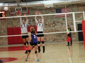 Meeker High School seniors Paige Jones and Reagan Pearce reach above the net to defend a high shot against Moffat County during a match in Aspen. The Lady Cowboys opened the season with four matches, winning three and losing one. “It was a good learning experience, but we have a lot to work on,” said first-year head coach Janae Stanworth. Meeker will play Vail Christian in Vail on Friday.