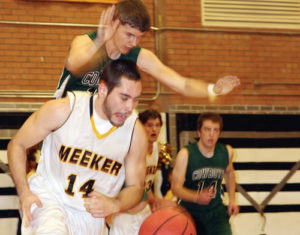 Cowboy senior Raul Lopez dribbles underneath a Plateau Valley defender in a game which Meeker won 60-42. The Cowboys remain undefeated 12-0 after a game against Rio Blanco County foe Rangely. The Panthers led for the first three quarters but the Cowboys came back in the fourth and won 42-36.