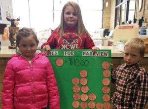 Parkview Elementary School kindergartener Brielle Lucero, fourth-grader Kenzie Varner and kindergartener Zane Wiley hold up a graph showing each grade’s contributions to the “Pennies for Parkview” fundraiser, which will raise money for local breakfast and after-school programs until Spring Break. The schools raised more than $230 in the first week.