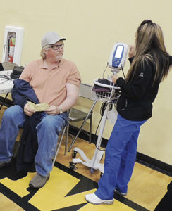 Roughly 600 area residents got out in spite of heavy snow Saturday to take part in the annual 9Health Fair. At right, students from the Colorado Northwestern Community College dental hygiene program joined the many other volunteers at the fair, checking blood pressure and oxygen retention. 