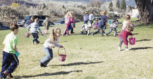 Meeker children launch toward Easter eggs scattered around the area during the annual hunt. 