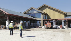 Above is the front view of construction on the new Pioneers Medical Center east of Meeker. In the photo are Margie Joy, right, the public information officer for the hospital and the executive director of the Pioneers Healthcare Foundation, and, left, Drew Varland, the hospital’s chief nursing officer, and Derek Smiun, a supervisor for Hazelton Construction, the project contractor. The hospital is slated for a late June opening, ahead of the original opening date in August.