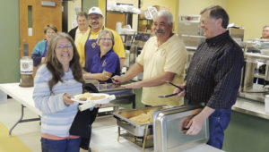 After having the tests she wanted to take at the 9Health Fair on Saturday morning at Meeker Elementary School, Angie Arnold of Meeker, front left, enjoyed the breakfast offered by the Meeker Lions Club and its members to those who took part in the health fair. The Lions offered free pancakes, syrup, sausage, eggs, orange juice and coffee to those who participated in the fair.