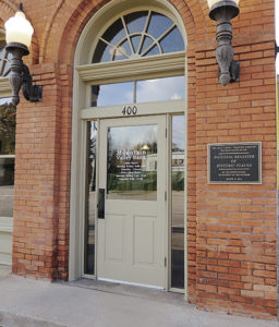 The front door of Mountain Valley Bank and a plaque denoting that the building is listed on the National Register of Historic Places.