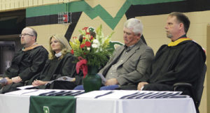 Honored guests on stage during Rangely High School’s commencement exercise at  Rangely Junior/Senior High School Sunday afternoon were, from left: RHS Vice Principal and athletic director Crandal Mergelman, Principal Dr. K.D. Bryant, commencement speaker Alan Ducey of Ducey’s Electric and Rangely School Superintendent Matt Scoggins.