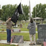 As part of the Rangely observance of Memorial Day on Monday, Pastor Mark Futch and Frank England raised the Prisoner of War flag at Rangely Cemetery as several onlookers watched.