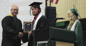 As voted on by the Class of 2015, the Rangely High School Teacher of the Year was Pat Walsh, who was presented with a plaque by Courtney Christiansen and Simone Heinle.