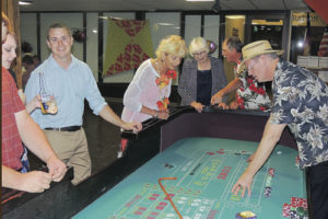 The sole craps table was a busy place Saturday night at the annual Pioneers Healthcare Foundation Gala dinner at the Fairfield Center. The event was a fundraiser for healthcare scholarships. Gathered around the craps table are Jesse Beauldette, far right, of Hazelden Construction, the contractor for the new hospital, and Meekerites (from the right of Beaudette) Debbie Cook, Diane Dunham and Jim Cook. At far right is one of the craps dealers, who were all from Denver.