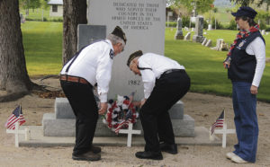 Bob Blevins, right, and Peter Kiser, left, lay a wreath upon the memorial to fallen members of the Meeker community during the Memorial Day observance held at Highland Cemetery on Monday morning. To the right is VFW Ladies Auxiliary member Dawn Jastrem, who assisted by carrying the wreath at both services on Monday. A good crowd gathered at the cemetery to observe the ceremony honoring those who gave their lives while in the Armed Forces in service to the United States.