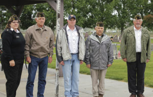 Bob Blevins, right, and Peter Kiser, left, lay a wreath upon the memorial to fallen members of the Meeker community during the Memorial Day observance held at Highland Cemetery on Monday morning. To the right is VFW Ladies Auxiliary member Dawn Jastrem, who assisted by carrying the wreath at both services on Monday. A good crowd gathered at the cemetery to observe the ceremony honoring those who gave their lives while in the Armed Forces in service to the United States.