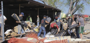 Several members of the Rangely High School football team along with coaches Paul Fortunato and Travis Witherell, were in Meeker on Tuesday at Bolton Construction, cleaning up the yard before leaving for football camp later this week in Greeley. “We wanted to help out and say thanks to Shawn Bolton and his lead man Joe Barton for their support of our program,” Coach Fortunato said. Fortunato said about 20 players will attend football camp at the University of Northern Colorado, where they have instruction during the day and scrimmages at night.