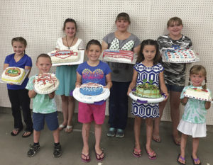 The winner of the Rio Blanco County Fair Cake Decorating Challenge is Natalie Knight, second from right in the front row. Knight was overall champion, having taken first place in Unit 1. Other winners were: Jessy Pelloni, who took second place in Unit 1; Cori Mohr, who took first place in Unit 2; Carys Walton, who took second place in Unit 2; Sierra Gomez, who took first place in Unit 4; Mary Baylie, who took first place in Unit 6; Jenna Pelloni, who took first place in pre-Cloverbud; and Holt Pelloni, who won first place in Cloverbud.