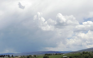 This big white cloud was eclipsed by this small dark cloud (upper left) resembling something like a dancing dog. Cloud formations have been sporting ever-changing images in the skies the past several weeks. 