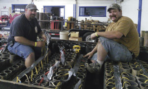 Certified pyro-technicians Zack Allen, left, and Rich Merriam, right, load three-, four- and five-inch tubes with fireworks shells on the main show trailer and wire them together in preparation for the Fourth of July show.