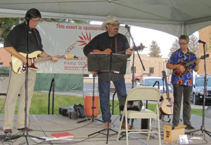 Jon Chandler, center, a long-time Front Range purveyor of country, Western, folk and bluegrass music, brought his band to Meeker on Friday for a concert on the courthouse lawn under the setting sun. The combined sounds of the electric guitar, acoustical guitar and the mandolin made for a highly entertaining concert of mixed country-style music. Sponsored by the ERBM Recreation and Park District as part of its 10th annual Summer Entertainment Series, there was a group of about 60 people in attendance.