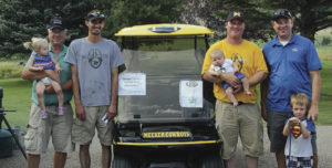 The defending champions of the annual Cowboy Kickoff Classic golf tournament all gave credit to the golf cart for their inspiration to defend their title. The champions were Jim Abshire (holding granddaughter Hadley), Matt Dupire, Andy Coryell (holding son Casey) and Eben Abshire (with son Westley).