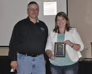 Scott Jones, left, president of the Colorado OHV Coalition, presented Katelin Cook, right, the director of economic development for Rio Blanco County, with an “Award of Special Recognition,” honoring Rio Blanco for the high quality of its Wagon Wheel Trails Program. The award was presented at an OHV workshop this summer.