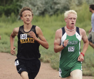Meeker High School’s Austin Russell, left, and Rangely High School’s Patrick Scoggins, right, run side by side during the weekend cross-country meet in Delta. Russell and Scoggins finished in 11th and 12th places, respectively.