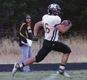 Cowboy statistician Bobby Shelton watches his son T.J. fly past him on his way to a 64-yard touchdown against the Platte Canyon Huskies, in the first round of the 1A Colorado State football playoffs. Shelton scored three touchdowns and rushed for 225 yards against the Huskies. Shelton—who has rushed for 1,691 yards so far this season—and his teammates will host the No. 2 Resurrection Christian Cougars on Saturday in Starbuck Stadium.